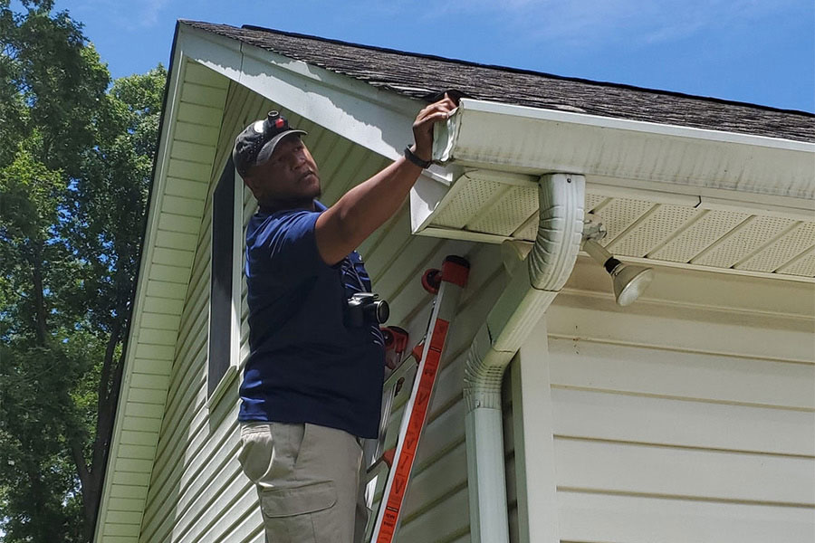 home-inspector-inspecting-gutter-and-house-climax-nc